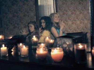 Jane Widdop and two other girls are posing in front of a mirror using their hands as a gun.